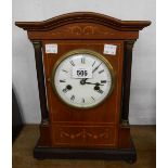 A late 19th Century German inlaid mahogany cased mantel clock with flanking slender columns and