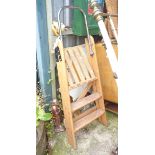 A small wooden step ladder with metal top rail