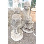 A set of four concrete garden statues depicting cricketers comprising batsman, bowler, wicket keeper