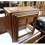 A quartetto set of Eastern hardwood tea tables with carved decoration, the smallest table with blind