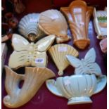 Eight Art Deco pottery wall pockets of various styles and shapes including Clarice Cliff shell form,