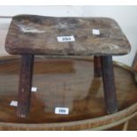An antique small rustic elm stool