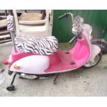 A pink child's ride on electric scooter with zebra print seat covers - a/f