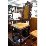 A late Victorian baronial style high back standard chair with carved decoration and barley twist