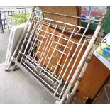 An old brass and iron bedstead with decorative target panels and turned finials