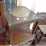A modern campaign style coffee table with map print under glass to top