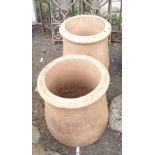 A pair of small terracotta chimney pots