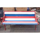 A three seater garden bench with cast iron ends and slatted wooden seat - sold with a two seater