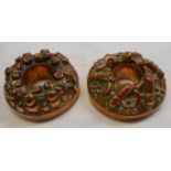 Two small Victorian ring form copper jelly moulds, one with a cannon and cannonball embossed design,