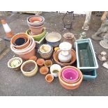 A large quantity of garden pots including ceramic, plastic, etc.