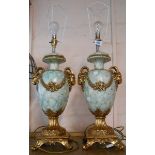 A pair of modern decorative lamps of baluster form with gilt ram's head handles and decorative