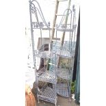 A pair of wrought iron garden corner shelves