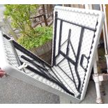 A folding plastic trestle table with metal legs - small hole to top