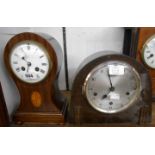 An Edwardian inlaid mahogany cased balloon shaped table clock with French eight day bell striking