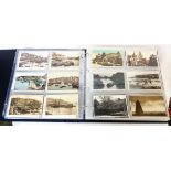 A large red ring bound album containing a collection of 300+ early and later 20th Century postcards,