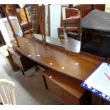 A 1.6m early G-Plan mixed wood bow front dressing table with triple mirror, central shelf and