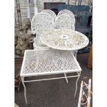 A cast aluminium patio set comprising table and four chairs - sold with a small wrought iron side