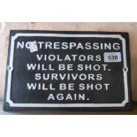 A modern cast metal No Trespassing sign