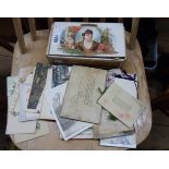 A cigar box containing assorted ephemera including postcards and old bank books, etc.