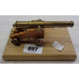 A small brass and wood model cannon