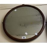 A stained walnut framed circular wall mirror - from a dressing table