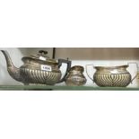 A silver plated three piece tea set of semi reeded oval design