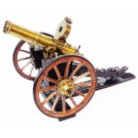 A painted metal and brass model Gatling gun - on named stand