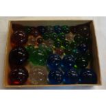 A box containing coloured glass marbles