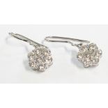 A pair of marked PT 950 flowerhead pattern drop er-rings, each set with seven diamonds - Rhapsody