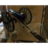 A painted metal model field cannon