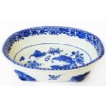 An antique Chinese porcelain footed bowl decorated in blue with hand painted butterflies and flowers