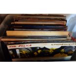 A crate containing a quantity of assorted LP records including The Police, Eurythmics, ABBA, etc.