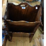 A vintage polished oak two tier magazine rack with pierced handle to top