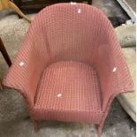 A vintage Lloyd Loom tub chair with original old rose sprayed finish and paper label