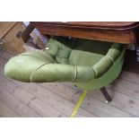 A Victorian drawing room tub elbow chair with button back upholstery, set on turned front legs