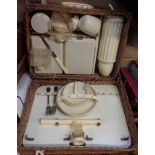 A vintage wicker picnic basket (a/f) and original contents including cups, saucers, plates,