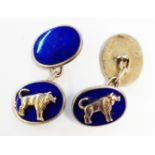 A pair of marked Silver and blue enamel oval panel cuff-links with applied bull motifs