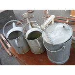 Two metal watering cans and metal bucket