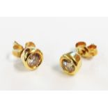 A pair of hallmarked 750 gold diamond stud ear-rings - boxed