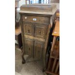 An old oak cabinet cased Edison Bell gramophone with storage cupboard under