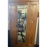 A 97cm Art Nouveau inlaid walnut single wardrobe with hanging space enclosed by a bevelled mirror