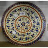 A Thoune pottery (Switzerland) charger decorated with a sgrafitto floral pattern highlighed in