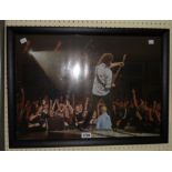 A framed coloured photographic reprint, depicting Brian May on stage at the O2 Arena - circa 2005