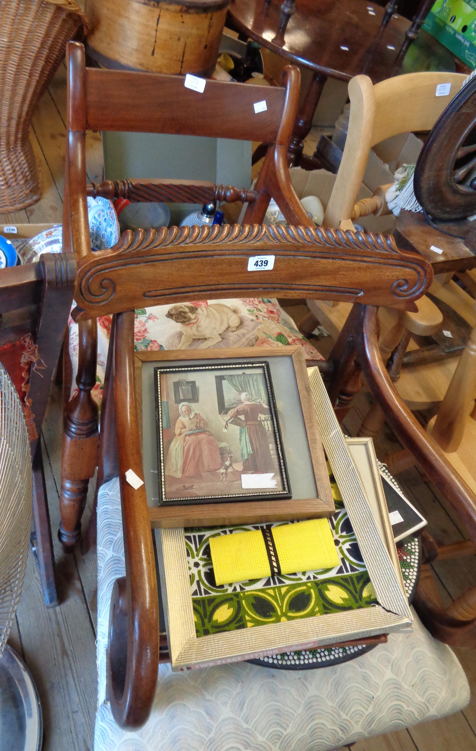 A late Regency mahogany framed open scroll elbow chair with upholstered seat, set on turned front