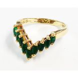 A marked 14k V-shaped ring, set with emeralds