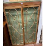 A 93cm old stripped wood astragal glazed cabinet with adapted interior and glass shelves