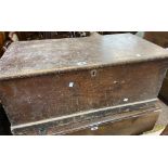 An 89cm Victorian stained pine lift-top trunk with internal candle box and flanking iron drop