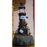 A vintage Cornish serpentine table lamp in the form of a lighthouse