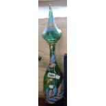 A large vintage coloured glass decanter and stopper with painted enamel and gilt decoration -