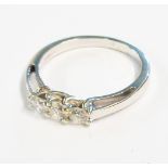 An 18ct. white gold three stone diamond ring